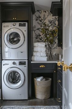 a washer and dryer in a small room with wallpaper on the walls