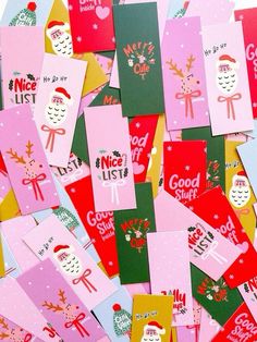 many different colored christmas cards on top of each other