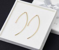 This is a pair of shaped gold filled wire earrings.Thick (18ga) 14K gold filled wire is curved elegantly and folded to form a half closed shape. The length is about 2"/1" (long/short arm). You will need earring holes to put them on. Packaged in my shop's premium quality gift box (see picture)Silver version and 14K rose gold filled version is available Minimalist Gold Wire Wrapped Earrings, Minimalist Wire Wrapped Drop Threader Earrings, Minimalist Wire Wrapped Gold Earrings, Work Earrings, Engraved Locket, Earring Hole, Earrings Dangle Simple, Memorial Necklace, Earrings Simple