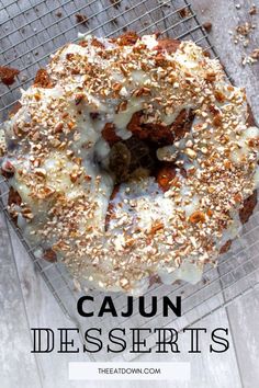 a close up of a doughnut on a cooling rack with the words cajun desserts above it