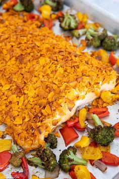 a casserole dish with broccoli, peppers and other vegetables on it