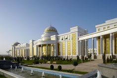 a large building with fountains in front of it