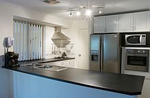 a kitchen with stainless steel appliances and white cabinets