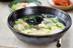 a bowl filled with soup sitting on top of a table