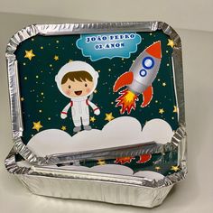 a tin tray with an image of a boy in space holding a rocket on it