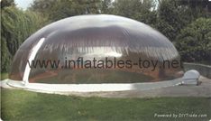 an inflatable dome tent sits on the grass