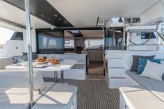 the interior of a boat with white furniture