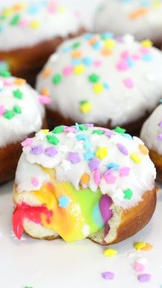 there are many donuts with white frosting and sprinkles