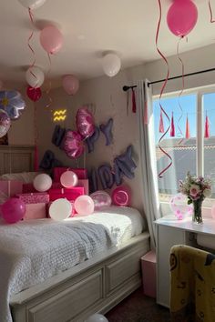 a bedroom decorated with balloons and streamers