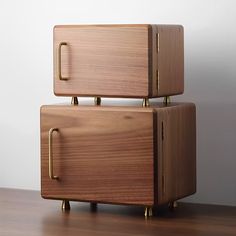 two wooden boxes stacked on top of each other