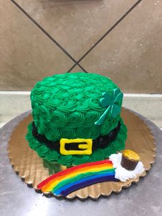 a st patrick's day cake with green frosting and a rainbow on top