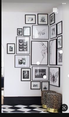 a white room with black and white pictures on the wall next to a cheetah stool