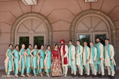 a group of people standing next to each other in front of a building