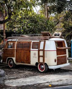 an old vw camper parked on the side of the road