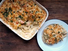 a casserole dish with chicken and spinach in it next to a white plate