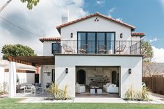 a white house with an attached deck and patio