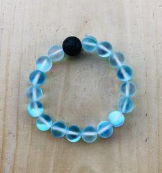 This listing is for one aqua glowing aura moonstone bracelet. This is a stretch bracelet. Adjustable Blue Luminous Jewelry, Adjustable Luminous Blue Jewelry, Mermaid Glass, Aqua Aura, Moonstone Bracelet, Stretch Bracelets, Live Lokai Bracelet, Moonstone, Aura