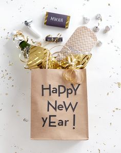 a new year's eve bag with gold decorations and confetti on it