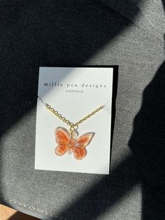 This absolutely adorable resin butterfly necklace is a MUST BUY!! Perfect for birthday gifts, holiday gifts, or even just the perfect accessory to any kind of outfit! If you would like to adjust necklace chain length, just add a comment when you place your order! Trendy Butterfly Jewelry For Gift, Trendy Butterfly Necklace For Gifts, Orange Butterfly Jewelry For Gifts, Orange Butterfly Jewelry Gift, Orange Butterfly-shaped Jewelry Gift, Trendy Butterfly Pendant Necklace For Gift, Trendy Butterfly Necklace With Adjustable Chain As Gift, Trendy Pink Butterfly Necklace For Gift, Trendy Pink Butterfly Necklace Gift