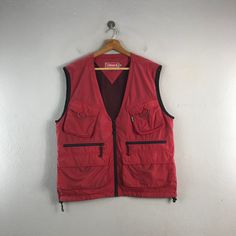 PLEASE READ DESCRIPTION BELOW BEFORE BUYING👇🏻 *ITEM:Vintage Coleman Vest *ITEM DETAILS: 👇🏻 Please be aware that all vintage items will usually show a few signs of wear or fading due to age, but anything visible such as stains or holes, and serious flaws have been photographed.For any further information on this item please contact us and we will be happy to help. *SIZE:LARGE *ACTUAL SIZE MEASUREMENT: 👇🏻 *PIT TO PIT(WIDTH):21""INCHES *LENGTH(FROM SHOULDER): 25"INCHES  *ALL MEASUREMENTS ARE TAKEN WITH THE GARMENT FLAT ON THE GROUND *VIEW FULL SHOP HERE: https://www.etsy.com/shop/Tracstore *SHIPPING: (WITH ONLINE TRACKING NUMBER ) *DHL EXPRESS SHIPPING:4-6 BUSINESS DAYS *Don't Worry About Customs Tax or Fees. I usually Declare As 'Gifts' And Low Value  *ANY QUESTION WILL ANSWER WITHIN 2 Retro Sleeveless Vest With Pockets, Vintage Outerwear With Pockets For Hiking, Vintage Outdoor Vest For Fall, Retro Fall Vest With Pockets, Vintage Vest For Outdoor Fall Activities, Retro Red Sleeveless Vest, Red Sleeveless Vest Outerwear, Red Sleeveless Retro Vest, Retro Red Outerwear With Pockets