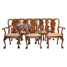 a set of six carved wood chairs with upholstered back and arms