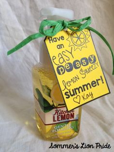 a bottle of lemon juice with a green ribbon around it and a sign that says, have an easy beachy lemon sauce