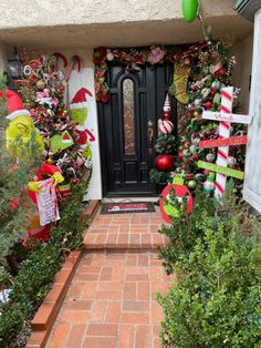 a front door decorated for christmas with candy canes and decorations