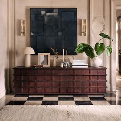 a living room with a checkered floor and large painting on the wall above it