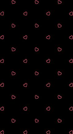 a black background with red and pink hearts in the dark, as well as smaller ones