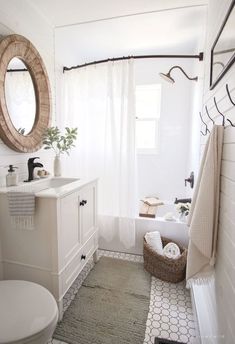 a bathroom with a toilet, sink, mirror and towel rack on the wall in it