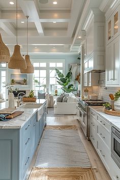 a large kitchen with white cabinets and blue counter tops, along with an island in the middle