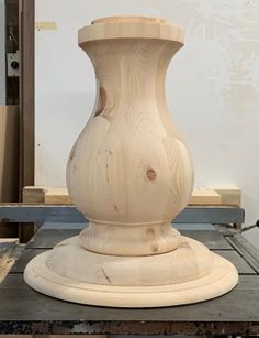 a large wooden vase sitting on top of a table