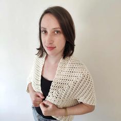 a woman wearing a white crochet shawl