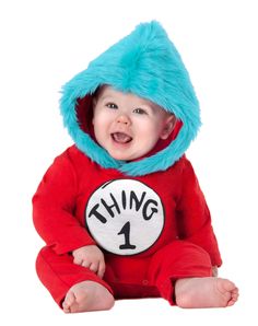 a baby wearing a thing 1 onesie with a cat in the hat on it