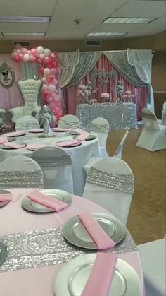 the tables are set up with pink and silver decorations