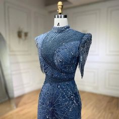 a blue dress on display in a room