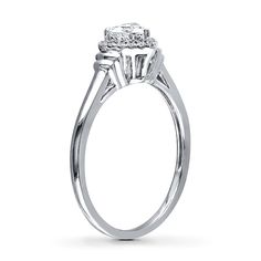 a diamond engagement ring with three stones on the side