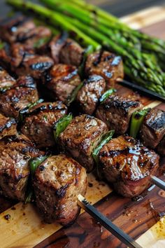 skewered steaks and asparagus on a cutting board