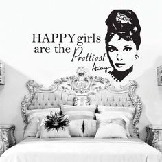 a bedroom with a wall decal that says happy girls are the prettiest