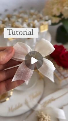 a person is holding a bow on a plate with flowers in the background and text that reads, how to make ribbon bows