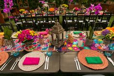 a table set with place settings and flowers