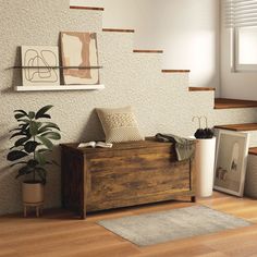 a wooden box sitting on top of a hard wood floor next to a potted plant