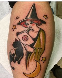 a woman with a book and a cat on her leg is shown in this tattoo design