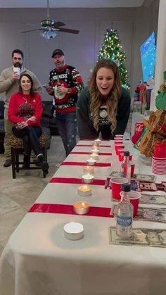 a group of people standing around a table