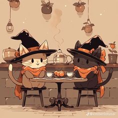 two cats dressed up as witches sitting at a table with cups and teapots