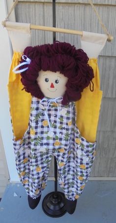 a doll hanging from a clothes line on top of a pole