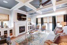 a living room filled with furniture and a fire place in the middle of a room