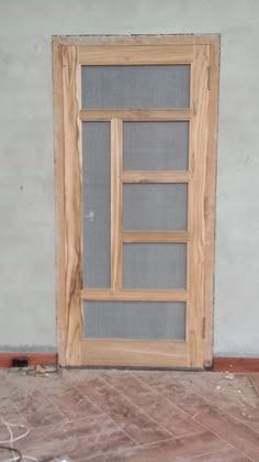 a wooden door sitting inside of a building