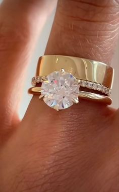 a woman's hand with a ring on it and a diamond in the middle