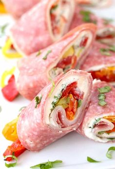 ham and vegetables rolled up on a white plate